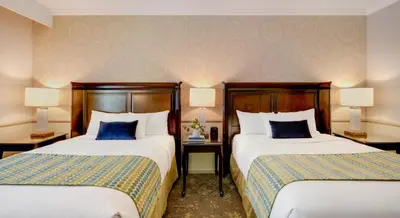 a hotel room with two beds and two lamps at Ayres Hotel Corona - Riverside in Corona