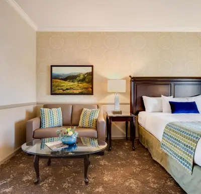 a hotel room with a bed and a couch at Ayres Hotel Corona - Riverside in Corona