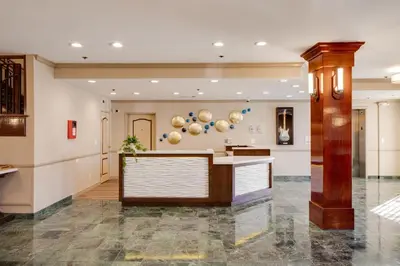 a lobby with a reception desk in a building at Ayres Hotel Corona - Riverside in Corona