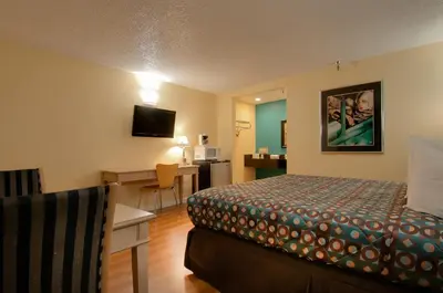 a hotel room with a bed and a desk at Vagabond Inn Bakersfield North in Bakersfield