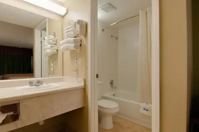 a bathroom with a sink and a toilet and a tub at Vagabond Inn Bakersfield North in Bakersfield