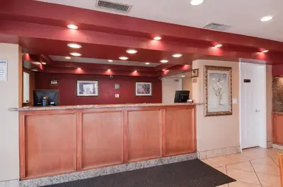 a bar in a waiting room with red walls at Vagabond Inn Bakersfield North in Bakersfield