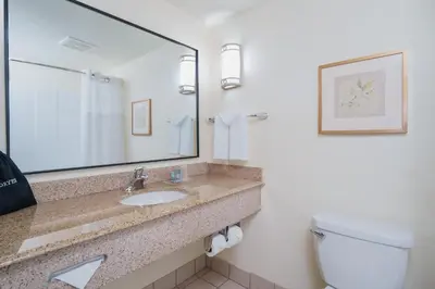 a bathroom with a sink and a toilet and a mirror at Best Western Ontario Mills Mall in Ontario
