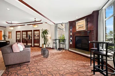 a living room with a couch and a fireplace at Best Western Ontario Mills Mall in Ontario