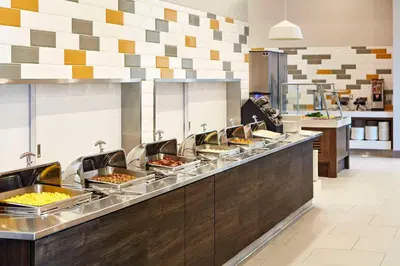 a buffet line with many trays of food at Anaheim Resort Suites in Anaheim