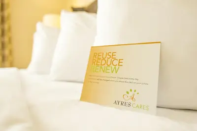 a sign sitting on top of a bed at Ayres Suites Yorba Linda/Anaheim Hills in Anaheim