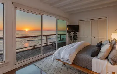 a bedroom with a bed with a view of the ocean at Malibu Beach Home Private Sandy Beach and Surf in Malibu