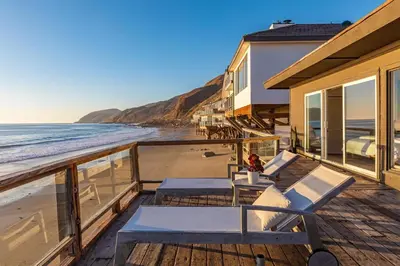 a balcony with chairs and a view of the beach at Malibu Beach Home Private Sandy Beach and Surf in Malibu