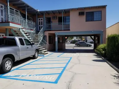 a truck parked in a parking lot in front of a building at Espana Motel in Norwalk