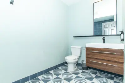 a bathroom with a white toilet and a sink at Magnolia Tree Hotel-Maingate/Anaheim Convention Center in Anaheim
