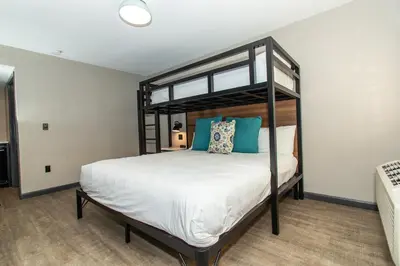 a bedroom with a large bed with blue pillows at Magnolia Tree Hotel-Maingate/Anaheim Convention Center in Anaheim