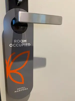 a door with a sign that says room occupied at Hotel Mariposa in Los Angeles