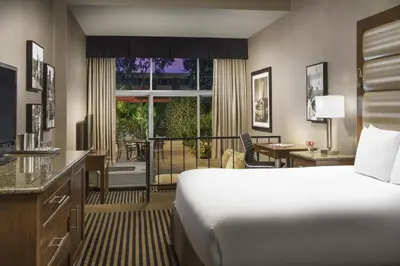 a hotel room with a bed and a balcony at USC Hotel in Los Angeles