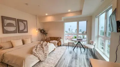 a living room with a couch and a table at Lovely Studio in heart of Hollywood in Los Angeles