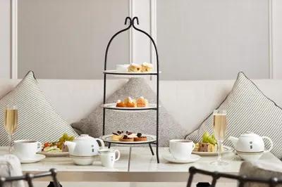 a table with several plates of food on a shelf at The London West Hollywood at Beverly Hills in Los Angeles
