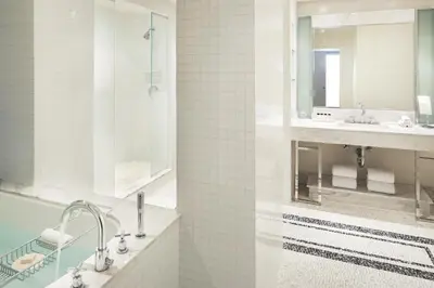 a bathroom with two sinks and a mirror at The London West Hollywood at Beverly Hills in Los Angeles