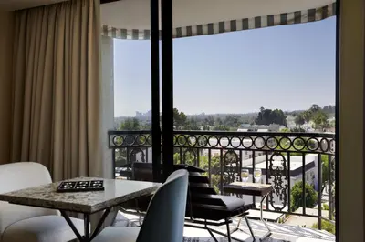 a room with a balcony with a table and chairs at The London West Hollywood at Beverly Hills in Los Angeles