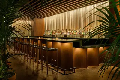 a bar in a building with a bunch of bottles at The West Hollywood EDITION in Los Angeles
