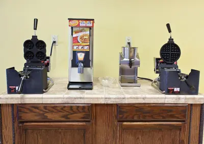a counter with two coffee machines on it at Landmark Inn Fort Irwin in Fort Irwin
