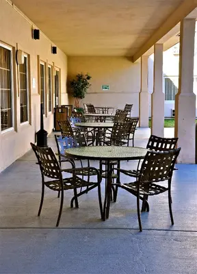 a group of tables and chairs in a patio at Landmark Inn Fort Irwin in Fort Irwin