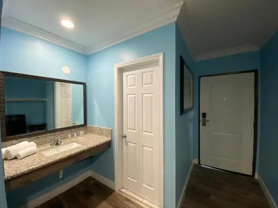 a bathroom with a sink and a mirror at Redondo Beach Motel - LAX in Gardena