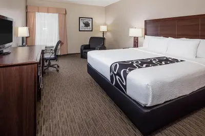 a hotel room with a bed and a desk and a television at La Quinta by Wyndham Inglewood in Inglewood
