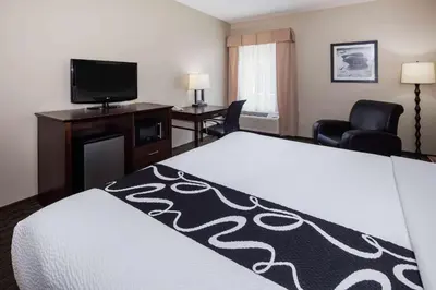 a hotel room with a bed and a flat screen tv at La Quinta by Wyndham Inglewood in Inglewood