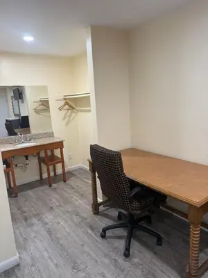 an empty office with a wooden table and a chair at Anaheim National Inn in Anaheim