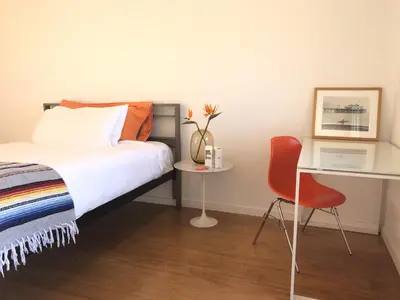 a bedroom with a bed and a desk and a chair at The M Malibu in Malibu