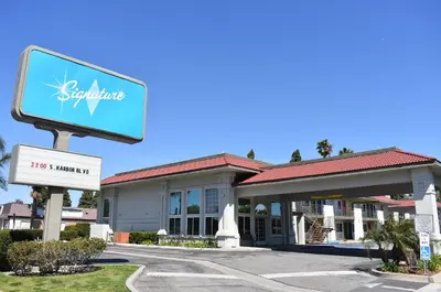 a sign in front of a hotel at Signature Anaheim Maingate in Anaheim