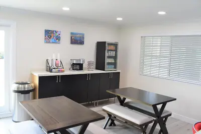 a dining room with a table and a table and a table and chairs at Signature Anaheim Maingate in Anaheim