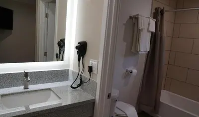 a bathroom with a sink and a mirror at Sea Breeze Inn - LAX Airport, Los Angeles in Inglewood