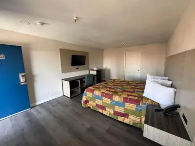 a hotel room with a bed and a television at Five Star Inn in West Covina