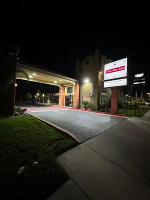 a building with a sign in front of it at night at Five Star Inn in West Covina