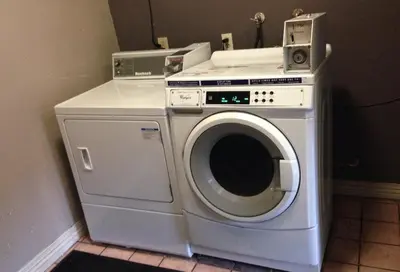 a washer and dryer sitting in a room at Five Star Inn in West Covina