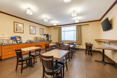 a restaurant with tables and chairs and a counter at Best Western Los Angeles Worldport Hotel in Wilmington