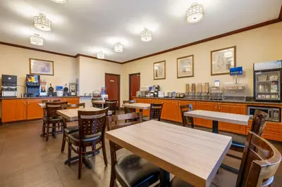 a restaurant with tables and chairs and a counter at Best Western Los Angeles Worldport Hotel in Wilmington