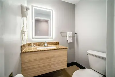 a bathroom with a sink and a toilet at Travelodge Inn & Suites by Wyndham Bell Los Angeles Area in Bell