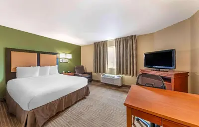 a hotel room with a bed and a flat screen tv at Extended Stay America Suites - Bakersfield - Chester Lane in Bakersfield