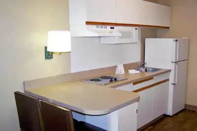 a small kitchen with a sink and a refrigerator at Extended Stay America Suites - Bakersfield - Chester Lane in Bakersfield