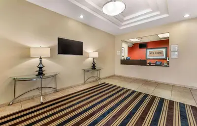 a living room with two tables and a flat screen tv at Extended Stay America Suites - Bakersfield - Chester Lane in Bakersfield