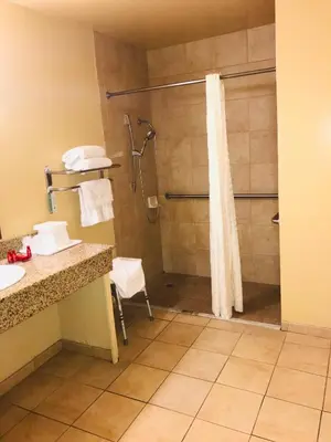 a bathroom with a shower with a shower curtain at Empire Inn in San Bernardino