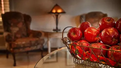 a basket of red apples on a glass table at Empire Inn in San Bernardino