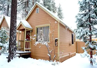 a cabin in the woods in the snow at Sleepy Forest Cottages in Big Bear Lake