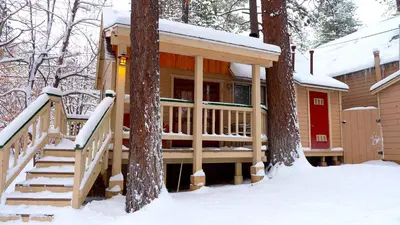 a cabin in the woods in the snow at Sleepy Forest Cottages in Big Bear Lake