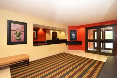 a waiting room with red walls and a mirror at Extended Stay America Suites - Los Angeles - Glendale in Glendale