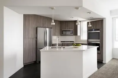 a kitchen with a white counter and a refrigerator at AKA Beverly Hills in Los Angeles