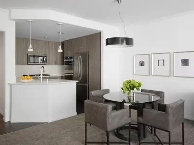 a kitchen with a table and chairs and a counter at AKA Beverly Hills in Los Angeles