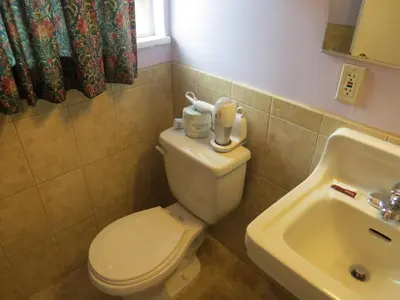 a bathroom with a toilet and a sink at Park Cienega Motel in Los Angeles