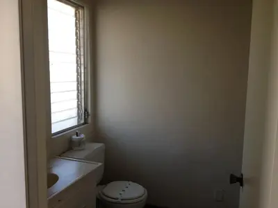 a bathroom with a toilet and a window at Golden Hills Motel in Tehachapi